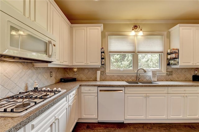 kitchen with white appliances, crown molding, sink, tasteful backsplash, and white cabinetry