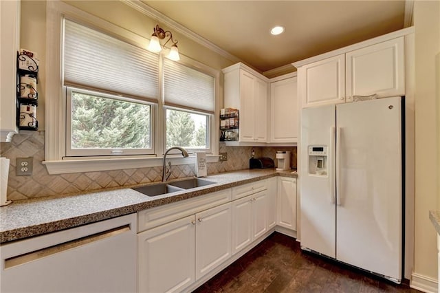 kitchen featuring sink, light stone countertops, white fridge with ice dispenser, dishwashing machine, and white cabinetry