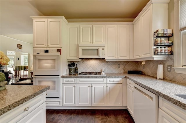 kitchen featuring backsplash, white cabinets, and white appliances