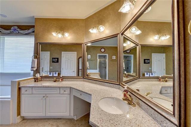 bathroom with vanity, a bath, and ornamental molding