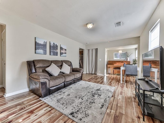 living room with light hardwood / wood-style flooring