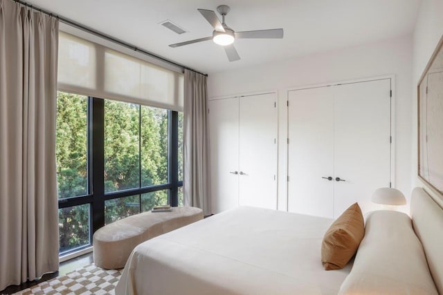 bedroom featuring two closets and a ceiling fan