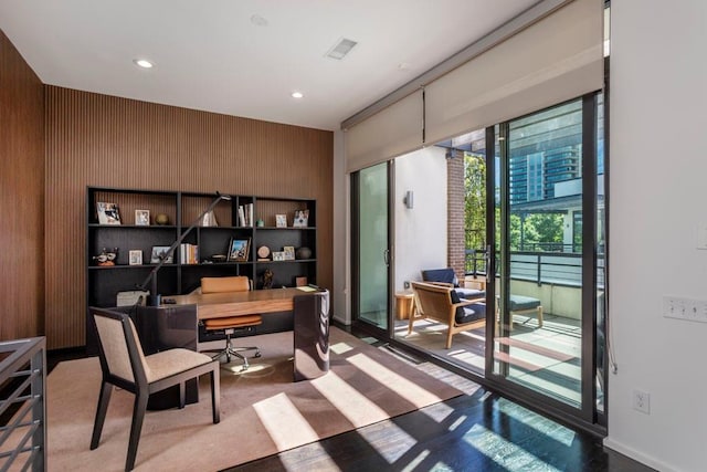 office with recessed lighting and wooden walls