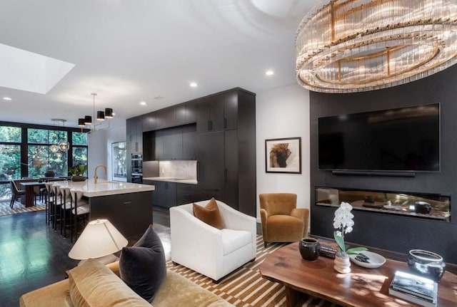 living area with a skylight, dark wood finished floors, recessed lighting, and floor to ceiling windows