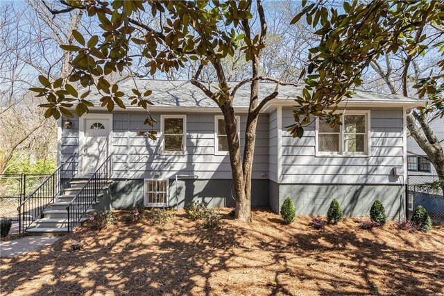 single story home featuring fence