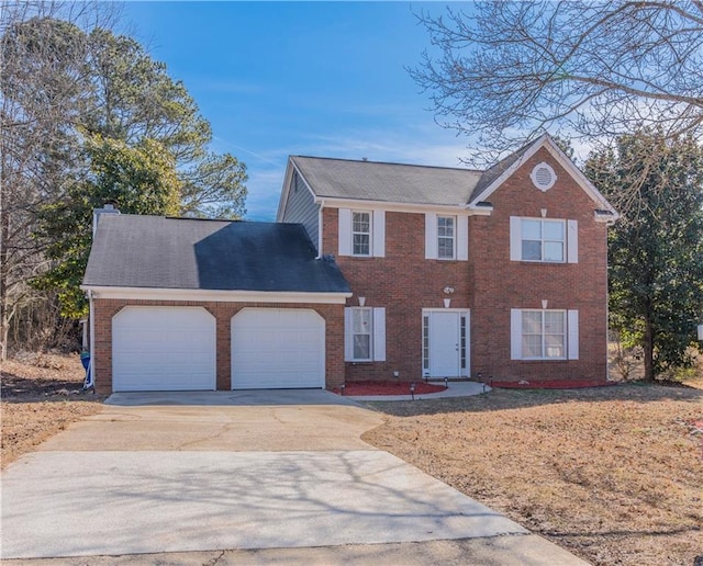 colonial home with driveway, brick siding, a chimney, and an attached garage