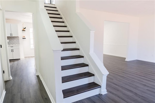 stairs featuring baseboards and wood finished floors