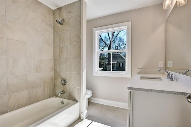 bathroom featuring toilet, washtub / shower combination, baseboards, and vanity