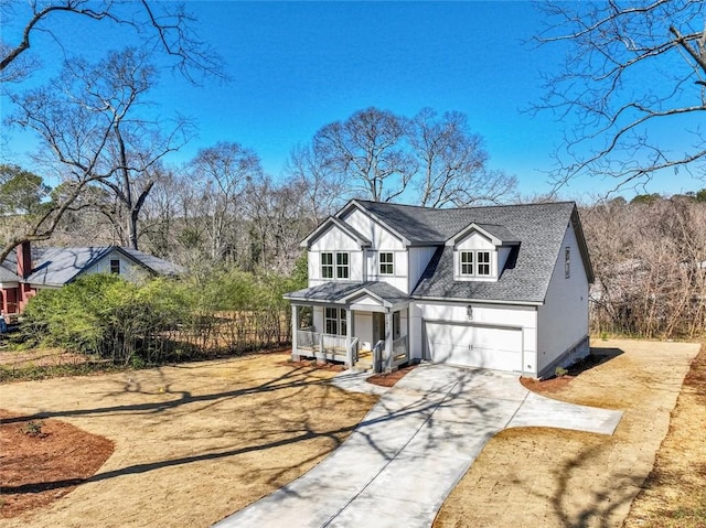 view of front facade featuring driveway, a garage, roof with shingles, a porch, and board and batten siding