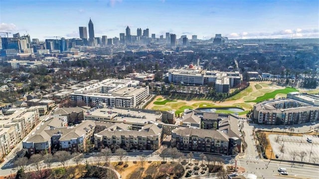 aerial view featuring golf course view and a view of city