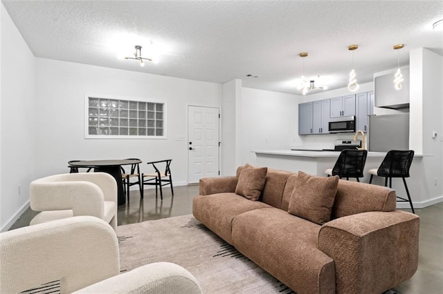 living room featuring baseboards, concrete floors, and a textured ceiling