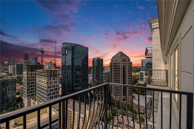 balcony at dusk with a view of city