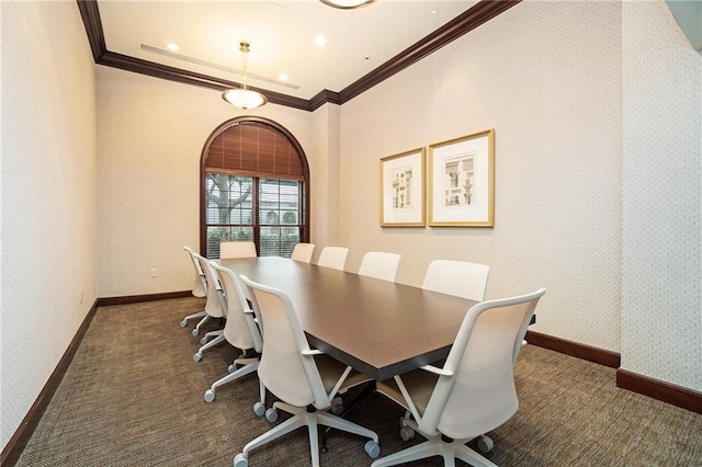 dining area featuring crown molding, dark colored carpet, baseboards, and wallpapered walls