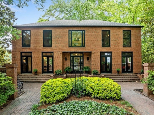 colonial house with french doors and brick siding