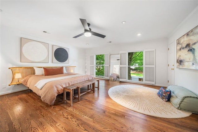 bedroom with wood finished floors, recessed lighting, baseboards, and ceiling fan