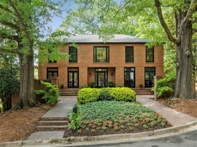 colonial inspired home with french doors and brick siding