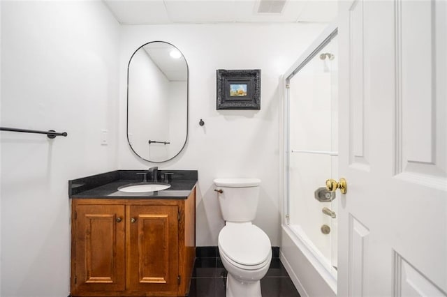 bathroom with vanity, toilet, tile patterned flooring, and a shower