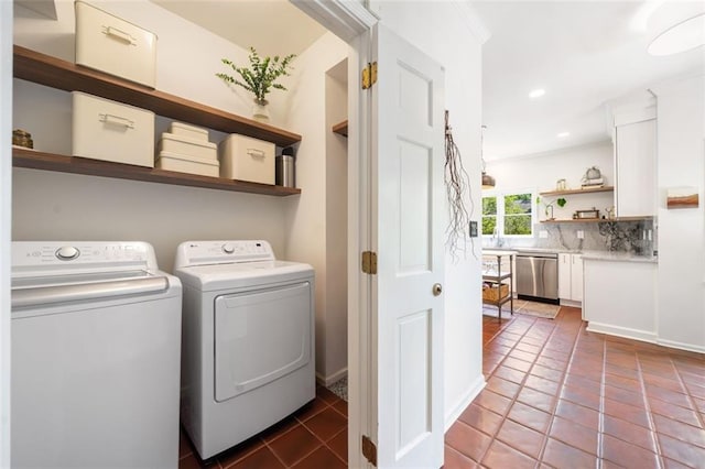 laundry room featuring washing machine and dryer, tile patterned floors, and recessed lighting