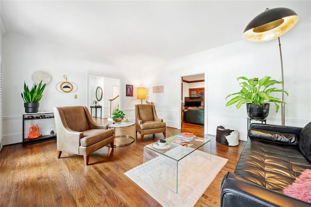 living room featuring wood finished floors and crown molding