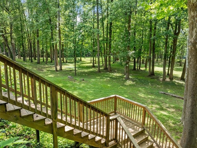 deck featuring a yard and stairway