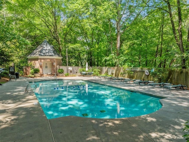 community pool featuring a patio area and a fenced backyard