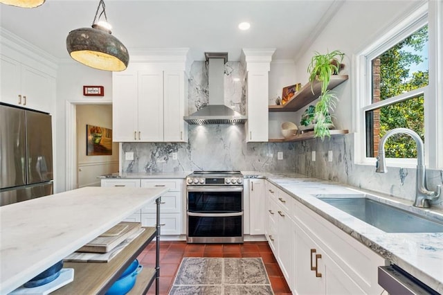 kitchen with wall chimney range hood, stainless steel appliances, a sink, healthy amount of natural light, and ornamental molding