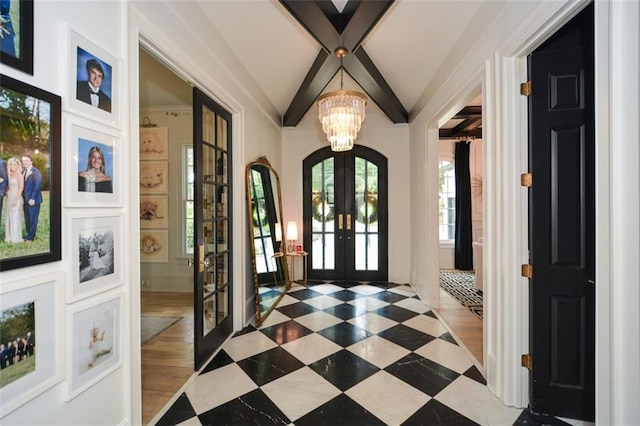 doorway to outside with french doors, lofted ceiling with beams, and an inviting chandelier