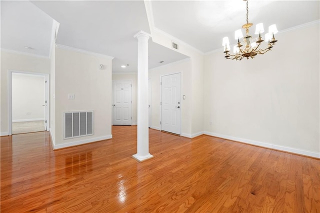 50 Biscayne Dr NW Unit 2113, Atlanta, GA 30309 - spare room with ornate columns, a chandelier, ornamental molding, and light wood-style floors
