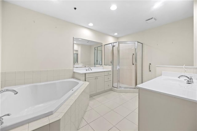 50 Biscayne Dr NW Unit 2113, Atlanta, GA 30309 - full bathroom featuring two vanities, a stall shower, a garden tub, tile patterned floors, and recessed lighting