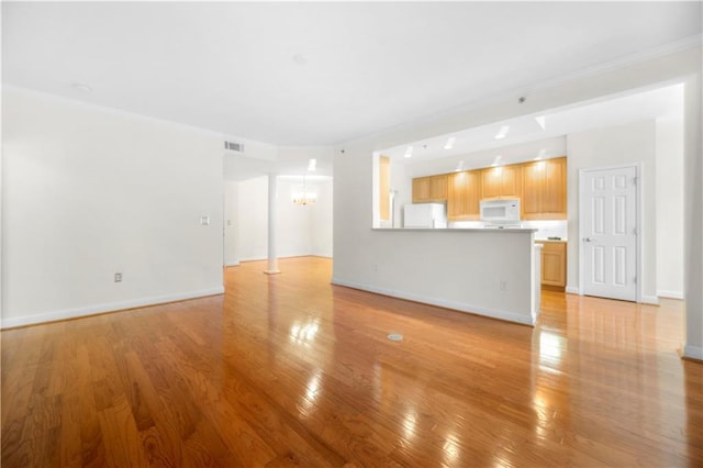 50 Biscayne Dr NW Unit 2113, Atlanta, GA 30309 - unfurnished living room featuring a chandelier, light wood-style flooring, and ornamental molding