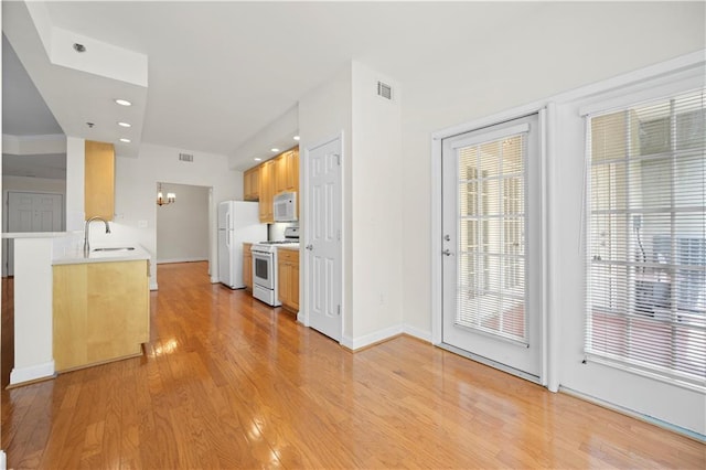 50 Biscayne Dr NW Unit 2113, Atlanta, GA 30309 - kitchen with white appliances, light countertops, light wood finished floors, and recessed lighting