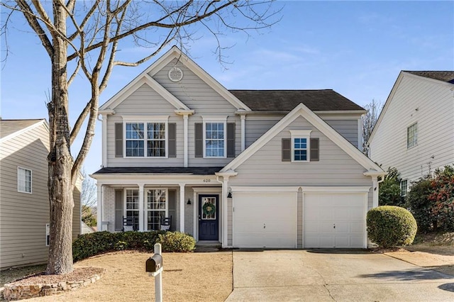 traditional home featuring driveway, a garage, and brick siding