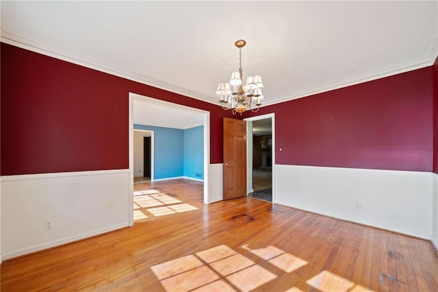 interior space with hardwood / wood-style flooring, a notable chandelier, and crown molding