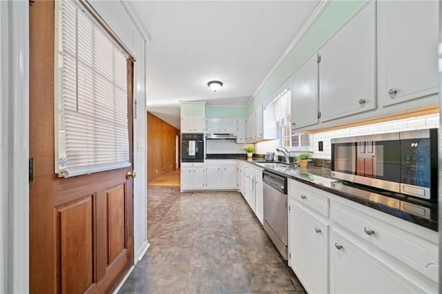 kitchen with stainless steel appliances, sink, white cabinetry, ornamental molding, and tasteful backsplash