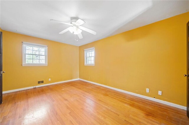 empty room featuring ceiling fan and wood-type flooring