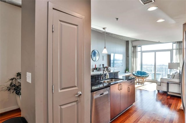 kitchen featuring sink, decorative light fixtures, dishwasher, floor to ceiling windows, and dark wood-type flooring