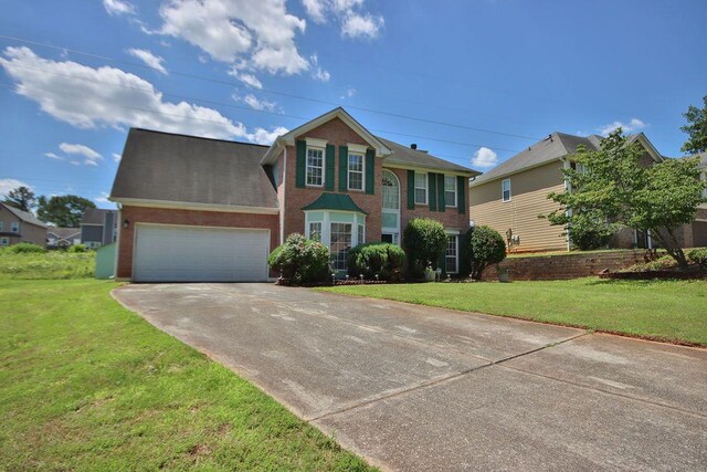 view of front of home with a garage and a front lawn