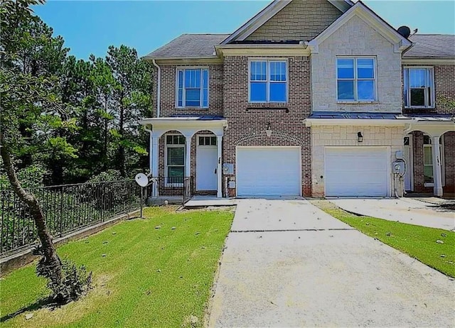 view of front of house with a front yard and a garage