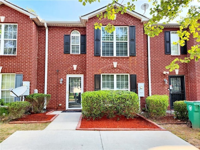 townhome / multi-family property featuring brick siding