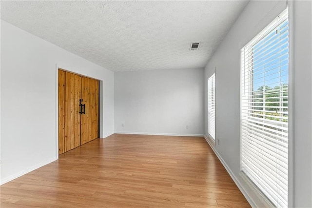 150 Crestworth Xing, Powder Springs, GA 30127 - unfurnished room with a textured ceiling and light wood-style flooring