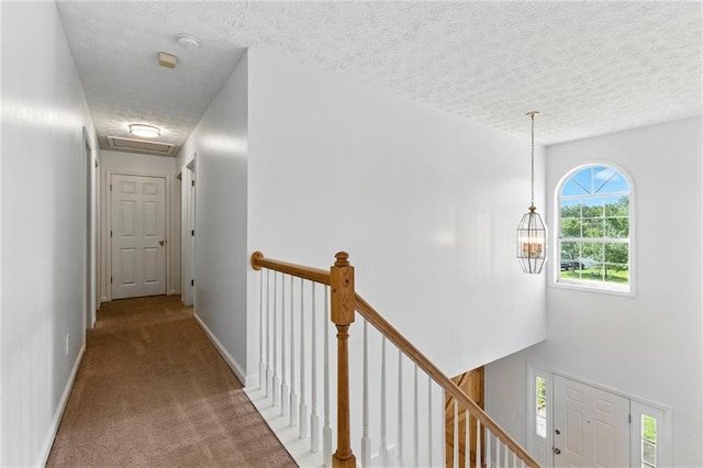 150 Crestworth Xing, Powder Springs, GA 30127 - hallway with an upstairs landing, a textured ceiling, and carpet floors