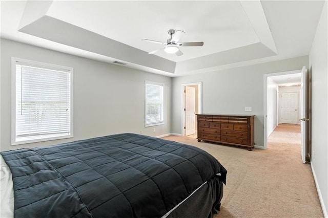 150 Crestworth Xing, Powder Springs, GA 30127 - bedroom featuring a tray ceiling, light carpet, and a ceiling fan