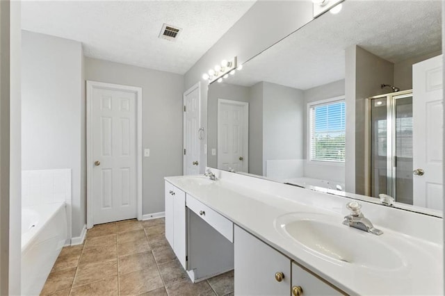 150 Crestworth Xing, Powder Springs, GA 30127 - full bathroom featuring a garden tub, a stall shower, double vanity, and a textured ceiling