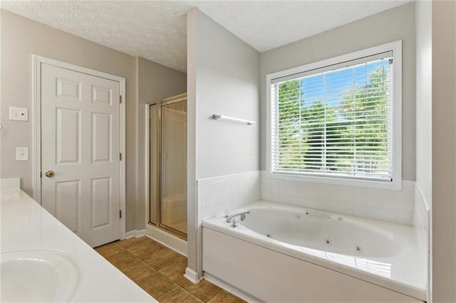 150 Crestworth Xing, Powder Springs, GA 30127 - bathroom featuring a whirlpool tub, a stall shower, double vanity, tile patterned flooring, and a textured ceiling