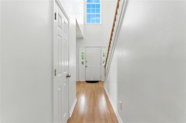 150 Crestworth Xing, Powder Springs, GA 30127 - hallway featuring light wood-type flooring and stairway