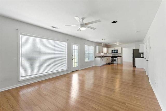 150 Crestworth Xing, Powder Springs, GA 30127 - unfurnished living room with a ceiling fan and light wood-style flooring