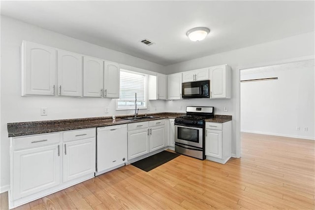 150 Crestworth Xing, Powder Springs, GA 30127 - kitchen with dishwasher, black microwave, gas range, white cabinetry, and light wood-style floors