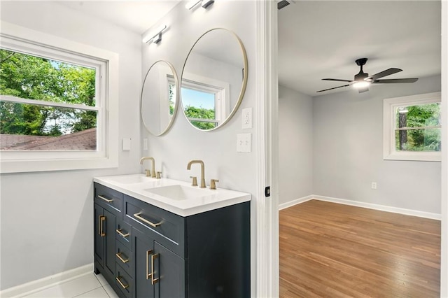 163 Oakcliff Ct, South Fulton, GA 30331 - bathroom with baseboards, double vanity, wood finished floors, and ceiling fan