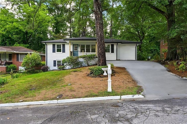 163 Oakcliff Ct, South Fulton, GA 30331 - view of front of property featuring asphalt driveway, a porch, and view of wooded area