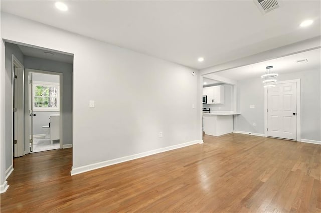 163 Oakcliff Ct, South Fulton, GA 30331 - unfurnished living room with light wood-style flooring, recessed lighting, and baseboards